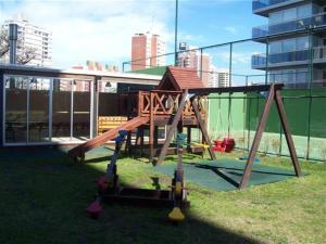 a playground with a slide in front of a building at Long Beach, Parada 3 in Punta del Este