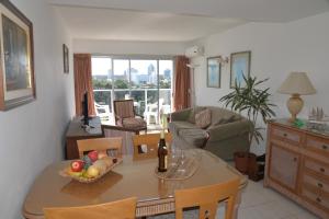 a living room with a table and a couch at Long Beach, Parada 3 in Punta del Este