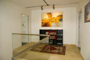 a staircase with a glass railing in a room at Pannonia Appartements in Neusiedl am See