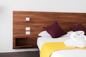 a hotel room with a bed with towels on it at Acate81 Lifestyle Apartment in Naples
