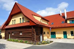 ein Blockhaus mit rotem Dach in der Unterkunft Hotel Agnes in Bohdaneč
