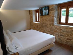 Postel nebo postele na pokoji v ubytování VILAR DE LEMA