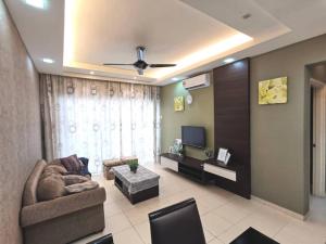 a living room with a couch and a tv at Menjalara Kepong Desapark & PJ 中文房东 B12 in Kuala Lumpur