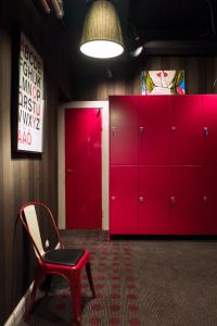 a red locker room with a red chair and a red cabinet at Hotel Finn in Helsinki