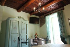 a bedroom with a bed with a chandelier and a window at B&B Panta Rei in Cicerale +54 photos