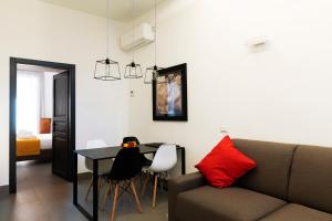 a living room with a couch and a table at Acate81 Lifestyle Apartment in Naples