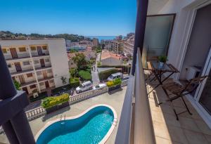 a view of a swimming pool on the balcony of a building at Apartamentos AR Melrose Place in Lloret de Mar