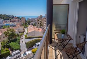 a balcony with a view of a city at Apartamentos AR Melrose Place in Lloret de Mar