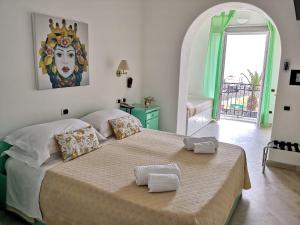 a bedroom with a large bed in a room at Hotel Ossidiana Stromboli Center in Stromboli