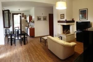 a living room with a couch and a fireplace at Villa del Sole in Manduria