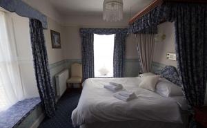 a bedroom with a large bed with a window at Union Hotel in Penzance