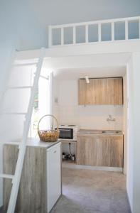 a kitchen with wooden cabinets and a counter top at Heracles Guesthouse in Rovies