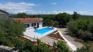 an aerial view of a house with a swimming pool at Vacation Home Daniela in Žgaljić