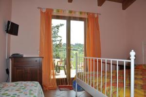 a bedroom with a bed and a window with a balcony at Bed and Breakfast Latteletto in Tortoreto Lido
