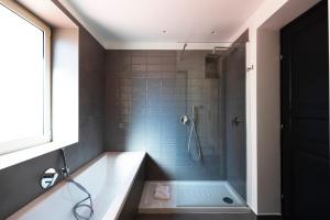 a bathroom with a bath tub and a shower at Acate81 Lifestyle Apartment in Naples