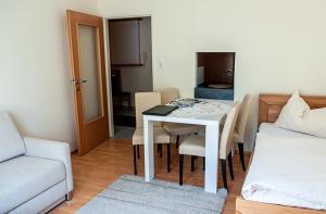 a living room with a table and a couch at Apartment am Bahnhof in Salzburg