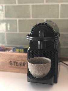 a black coffee maker with a white bowl in it at STOERbuiten Lodges Mar Y Sierra in San Costanzo