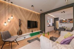 a living room with a couch and a tv at Urban Eden - LUX & STYLE, 2-Bedroom, 2-Bathroom in Sofia +28 photos