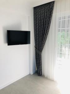 a living room with a television and a window at Ada Apart Hotel Göcek in Göcek