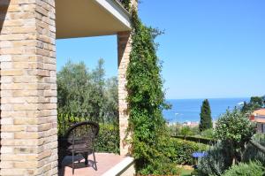 a bench sitting on a porch with a view of the ocean at Bed and Breakfast Latteletto in Tortoreto Lido