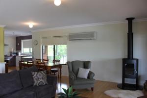 a living room with a couch and a stove at Waterside View in Augusta