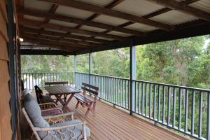 a screened porch with a table and chairs on it at Waterside View in Augusta