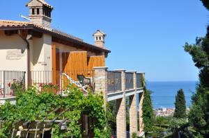 a house with a balcony with a view of the ocean at Bed and Breakfast Latteletto in Tortoreto Lido