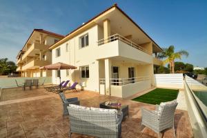 a house with a patio and a swimming pool at Nissi Martha Apartment in Ayia Napa
