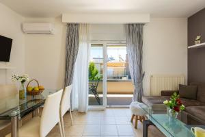 a living room with a couch and a table at White Coral in Rethymno Town