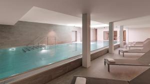 a large swimming pool with a large mirror at Hotel the YARD in Berlin