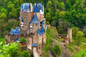 an old castle with blue roofs on a hill at Ferienwohnung Scheid in Lahr