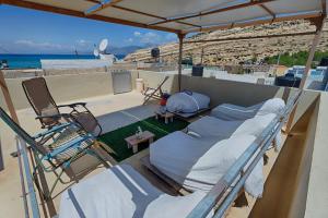 two beds on a balcony with a view of the ocean at Fantastic Matala 1 in Matala
