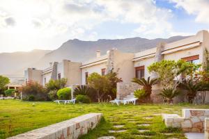 a group of buildings with mountains in the background at Amatu Villa (Hermes) in Xerokampos