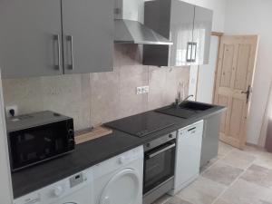 a kitchen with a sink and a stove top oven at Appartement Domaine l'Oliveraie in Le Castellet