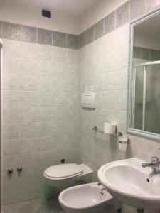 La salle de bains est pourvue de toilettes et d'un lavabo. dans l'établissement Hotel Saint Tropez, à Riccione