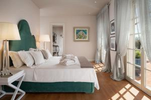 a bedroom with a large white bed and a window at Villa Ivana in Vabriga +46 photos