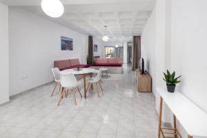 a living room with a table and chairs at MV83 new marina in Rhodes Town