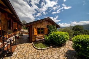 a log cabin with a porch and stairs to it at Ethno Village Pajo in Herceg-Novi