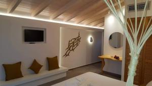 a living room with a tv on a wall at Oasis Exclusive in Parga
