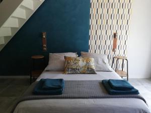 a bed with two pillows on it in a room at Les Perluètes - Chambres d'hôtes in Carennac +28 photos
