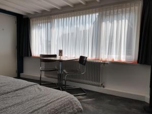 Postel nebo postele na pokoji v ubytování Hoogland aan Zee