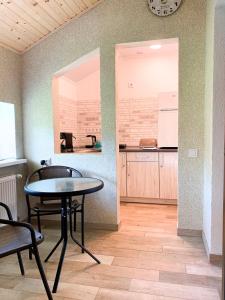 a table and chairs in a room with a kitchen at Апартаменти "Золота Баня" in Skhidnitsa