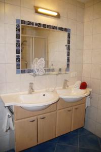 a bathroom with two sinks and a mirror at Haus Gaby in Holzgau +22 photos