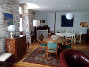 a dining room with a table and chairs at AUX ROSIERS in Salies-de-Béarn