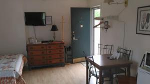 a bedroom with a table and a bed and a dining room at Midway Lodging in Cornish