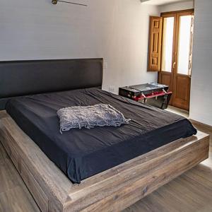 a large bed with a wooden frame in a bedroom at B&B Residenza San Giorgio in LʼAquila