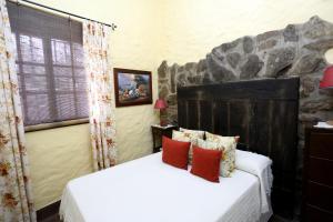 a bedroom with two beds and a stone wall at Llano San Ignacio in El Bosque