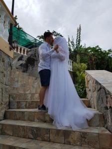 a man and a woman standing on some stairs at Hibiscus House Seychelles Self Catering in Victoria
