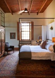 a bedroom with a large bed and a window at Jonkmanshof - 20 Bath in Montagu