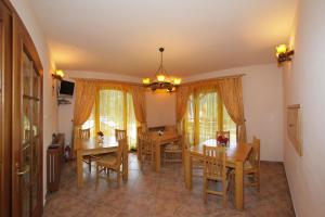 a dining room with wooden tables and chairs at Casa Anca Boutique Hotel in Braşov